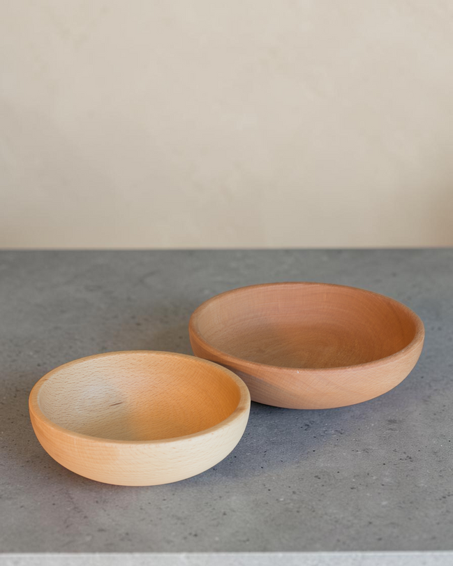 Ecohub NZ Entertainers Beech Nesting Bowl Set of 2 - natural beech wood - empty sitting side-by-side on a textured grey concrete surface
