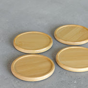 Ecohub NZ Essentials Bamboo Coaster Set of 4 - natural bamboo - laid out flat separately on a grey concrete surface