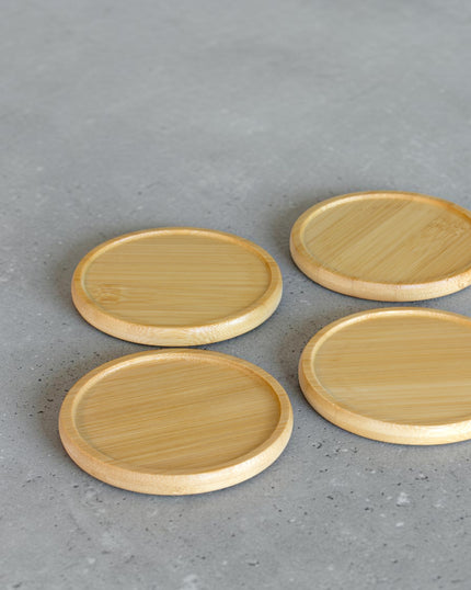 Ecohub NZ Essentials Bamboo Coaster Set of 4 - natural bamboo - laid out flat separately on a grey concrete surface