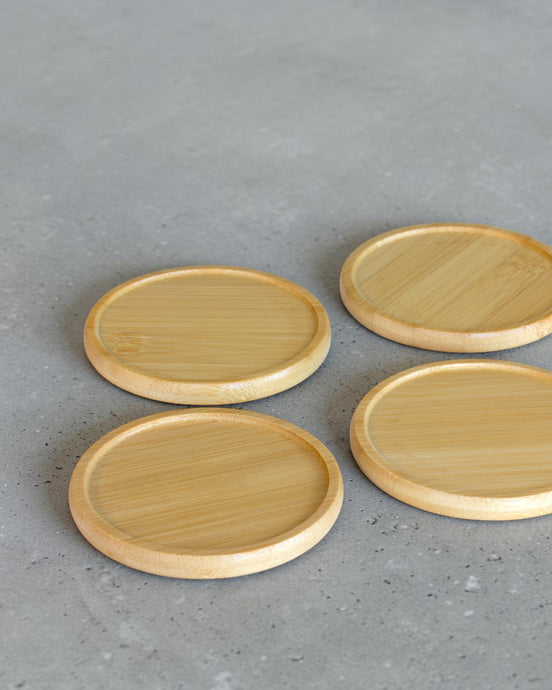 Ecohub NZ Essentials Bamboo Coaster Set of 4 - natural bamboo - laid out flat separately on a grey concrete surface