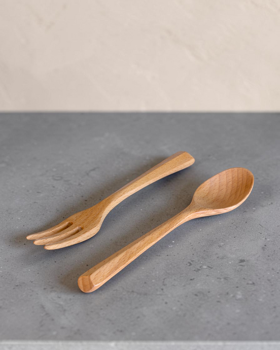 Ecohub NZ Entertainers Beech Cutlery Set of 2 - natural beech wood - fork and spoon resting on a grey concrete surface