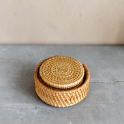 Ecohub NZ Artisans Rattan Coaster Set of 6 - natural woven rattan - stacked inside holder on grey concrete