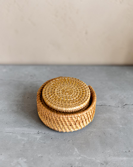 Ecohub NZ Artisans Rattan Coaster Set of 6 - natural woven rattan - stacked inside holder on grey concrete