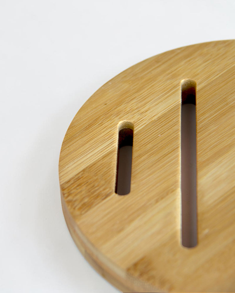 Ecohub NZ Essentials Bamboo Trivet (18cm) - natural bamboo - close-up detail showing slots and wood grain on white