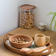 Ecohub NZ Entertainers Beech Cutlery Set of 2 - natural beech wood - resting on a woven tray with food on a wood counter