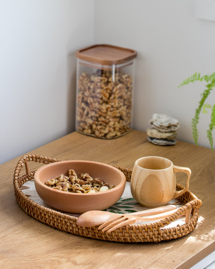 Ecohub NZ Entertainers Beech Cutlery Set of 2 - natural beech wood - resting on a woven tray with food on a wood counter