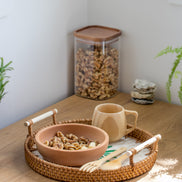 Ecohub NZ Artisans Rattan & Pearl Inlay Round Serving Tray (28cm) - rattan and pearl - holding snacks on wood counter