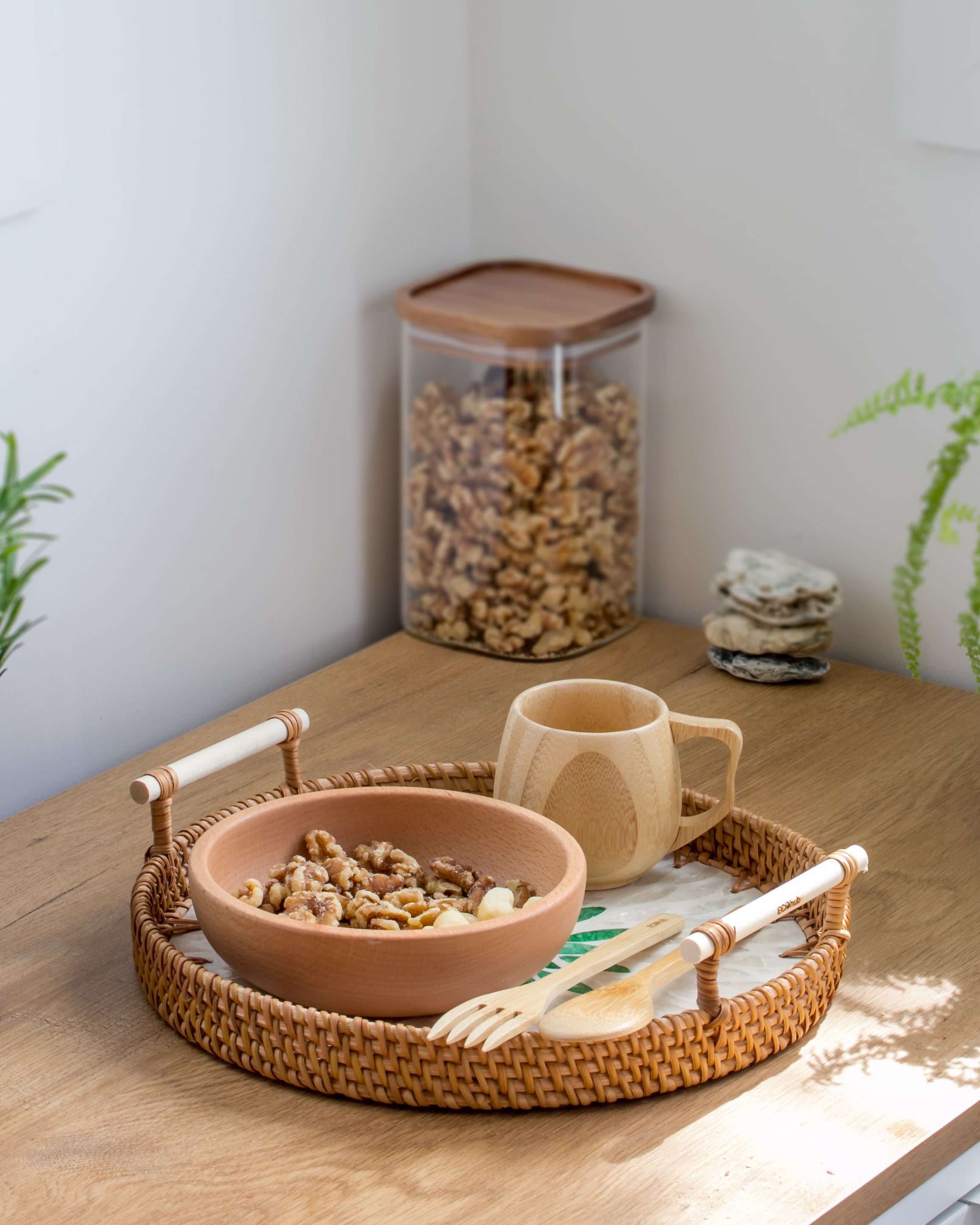 Ecohub NZ Artisans Rattan & Pearl Inlay Round Serving Tray (28cm) - rattan and pearl - holding snacks on wood counter