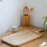 Ecohub NZ Entertainers Ash Serving Paddle Board (50x20cm) - natural ash wood - empty on a sunlit wooden kitchen counter