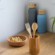 Ecohub NZ Essentials Bamboo Cutlery Set of 2 - natural bamboo - standing in a bamboo cup on a wooden kitchen counter