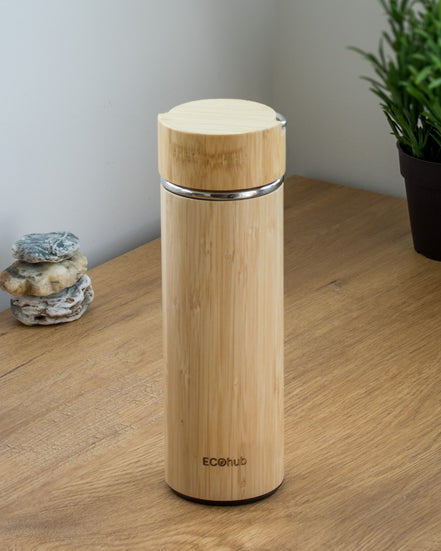 Ecohub NZ Essentials Bamboo Insulated Water Bottle (500ml) - natural bamboo and steel - standing on a wooden desk with plant
