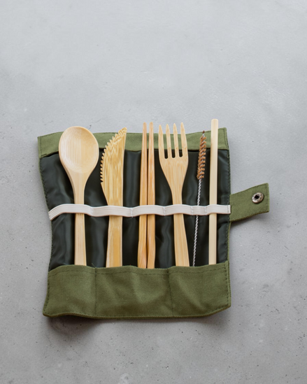 Ecohub NZ Essentials Bamboo Travel Cutlery Set of 7 - natural bamboo - unrolled in a green pouch on grey concrete