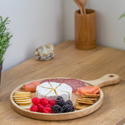 Ecohub NZ Entertainers Ash Round Paddle Board (35x25cm) - natural ash wood - serving charcuterie on a wood counter