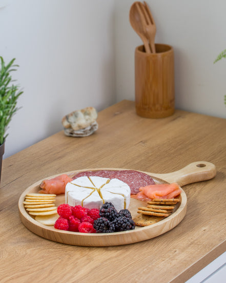 Ecohub NZ Entertainers Ash Round Paddle Board (35x25cm) - natural ash wood - serving charcuterie on a wood counter
