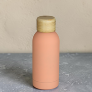 Ecohub NZ Palette Mini Insulated Water Bottle (350ml) Soft Peach - matte and bamboo - standing on a grey concrete surface