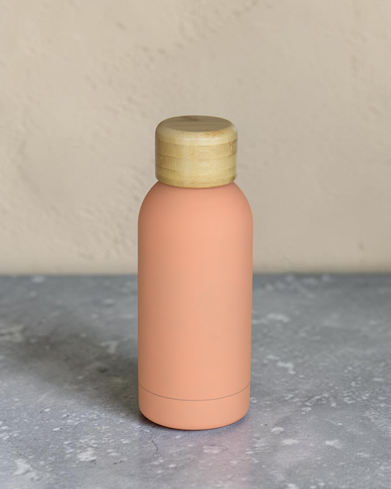 Ecohub NZ Palette Mini Insulated Water Bottle (350ml) Soft Peach - matte and bamboo - standing on a grey concrete surface