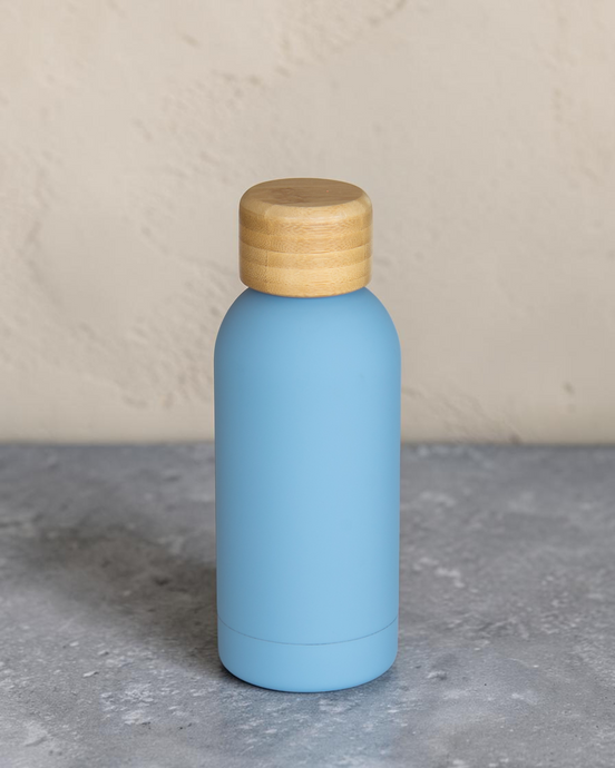 Ecohub NZ Palette Mini Insulated Water Bottle (350ml) Sky Blue - matte and bamboo - standing on a grey concrete surface