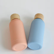 Ecohub NZ Palette Mini Insulated Water Bottle (350ml) Sky Blue - matte and bamboo - lying down next to a peach bottle