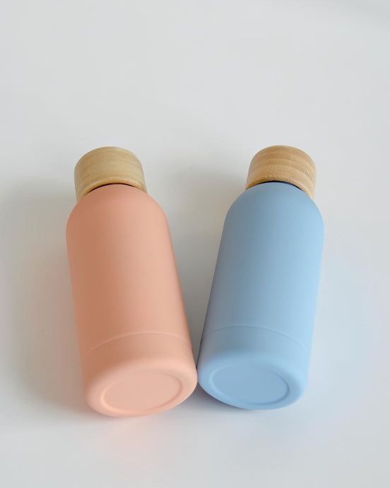 Ecohub NZ Palette Mini Insulated Water Bottle (350ml) Sky Blue - matte and bamboo - lying down next to a peach bottle