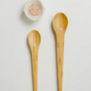Ecohub NZ Essentials Bamboo Mixing & Serving Spoons Set of 2 - natural sustainable bamboo - flat lay with a white shell bowl containing seeds
