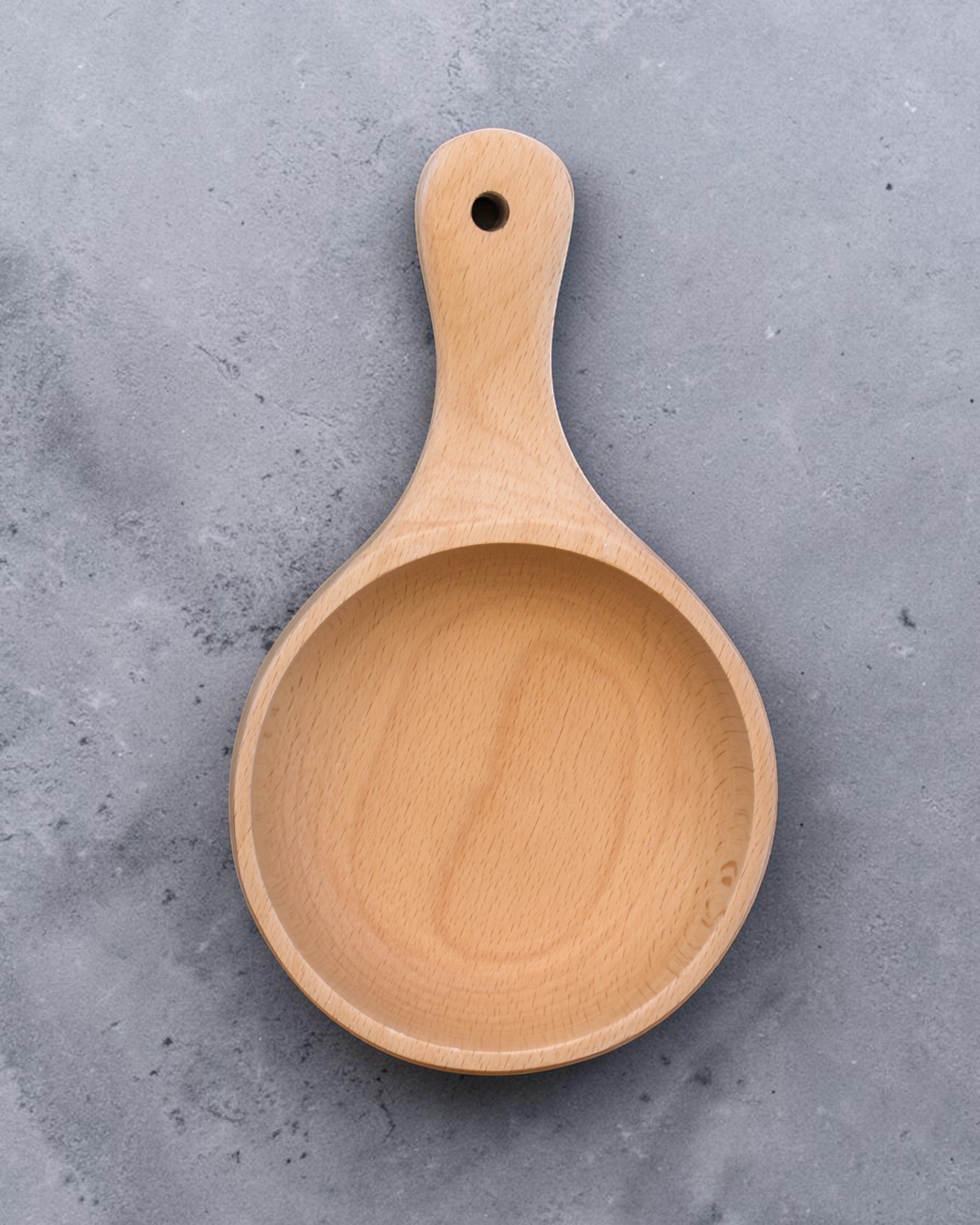 Ecohub NZ Entertainers Beech Handled Snack Bowl (15cm) - natural beech wood - top-down view empty on a textured grey concrete surface